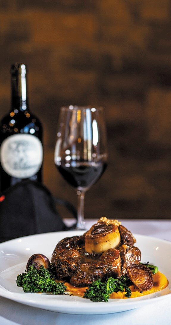 a plate of food and a glass of wine