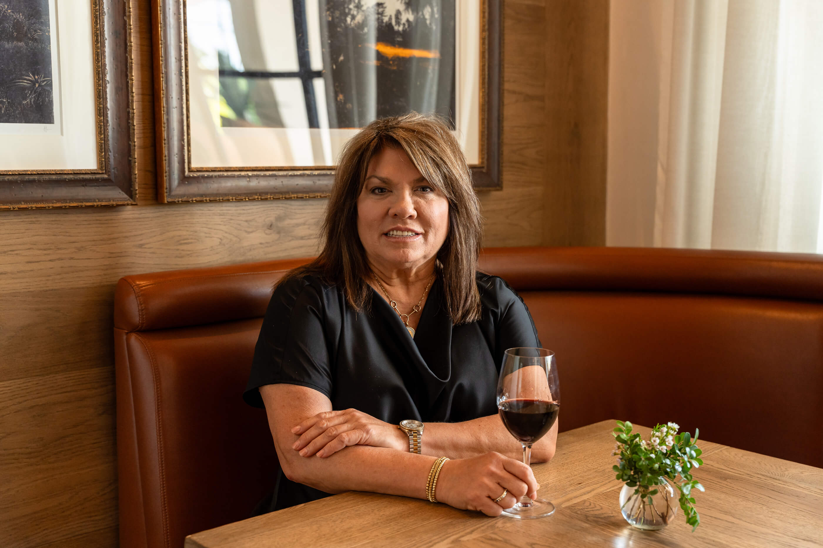 Lauren Hernandez sitting on a table with a wine glass