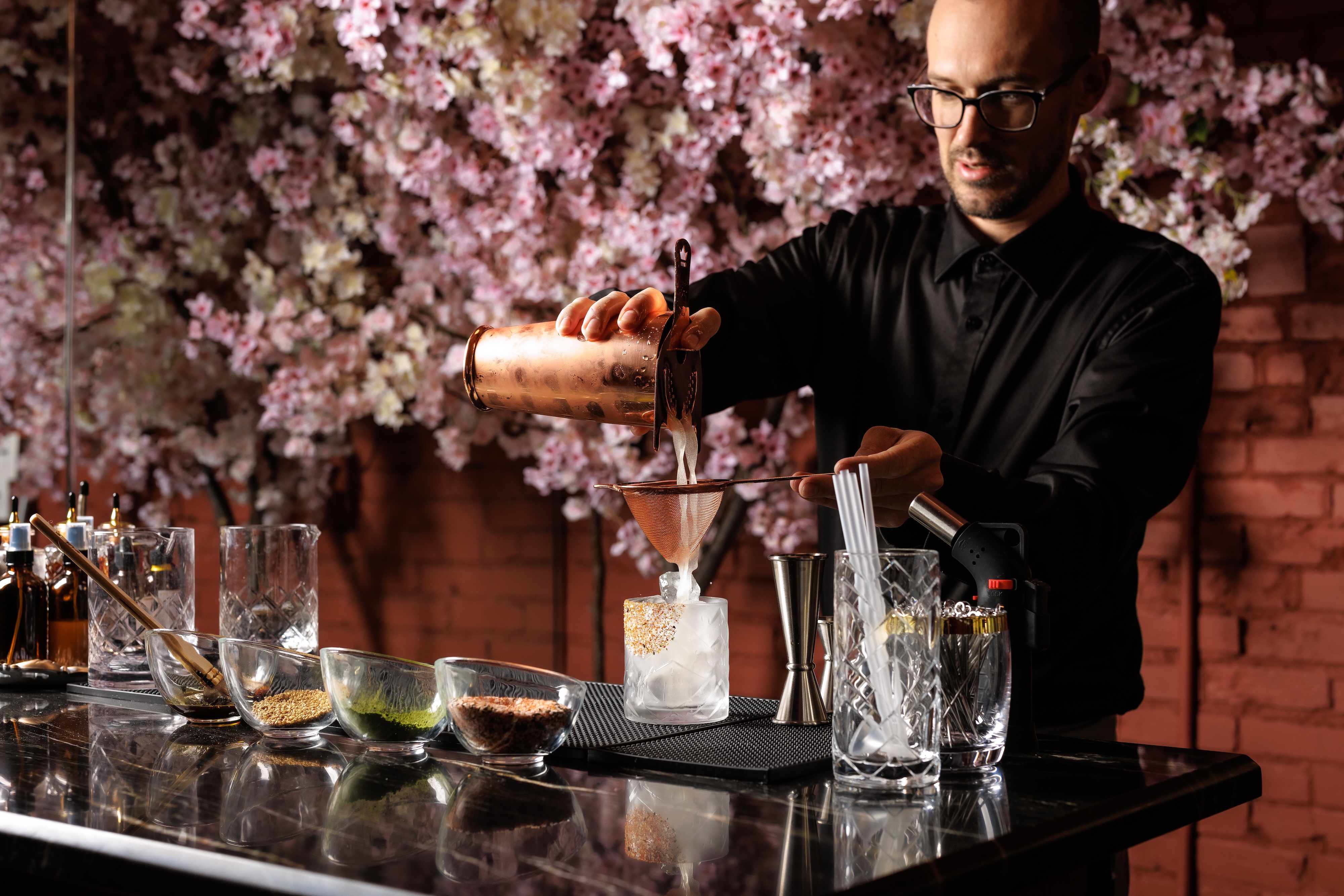 a man preparing a cocktail