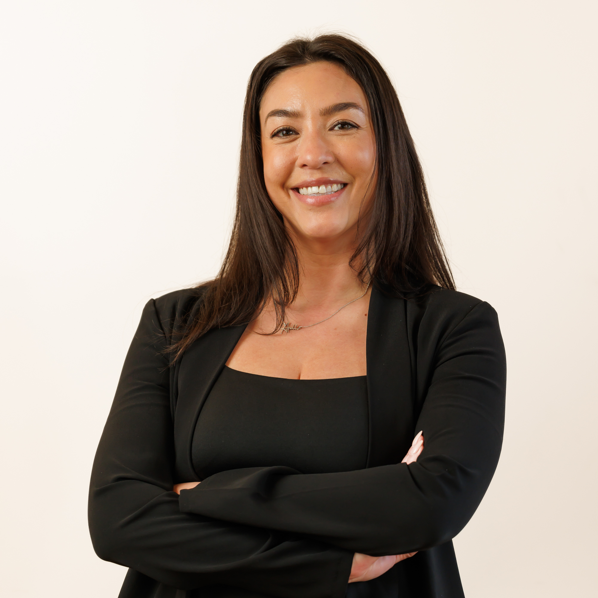 a woman with long hair wearing a black jacket and black shirt