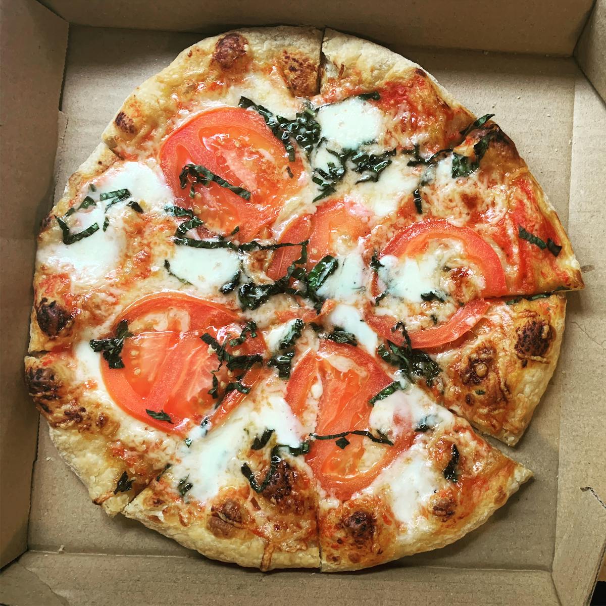 a pizza sitting on top of a cutting board