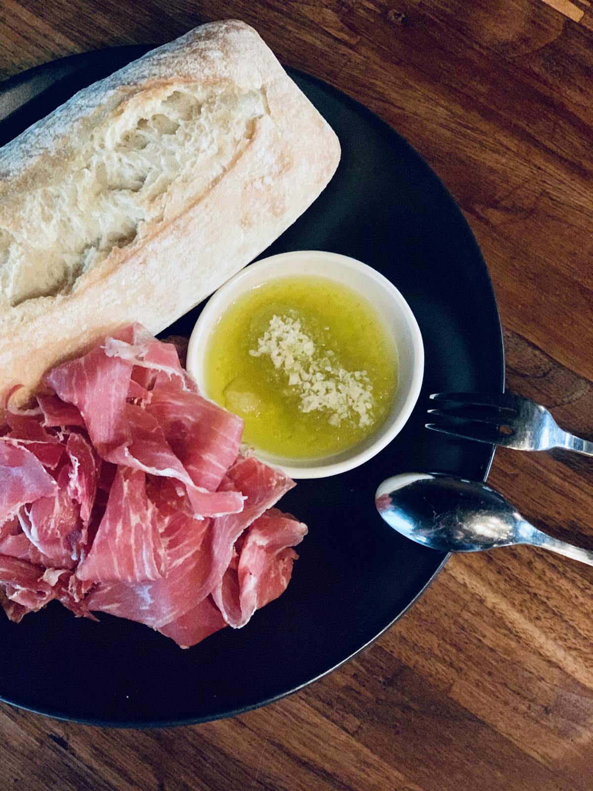 a plate of food sitting on top of a wooden table