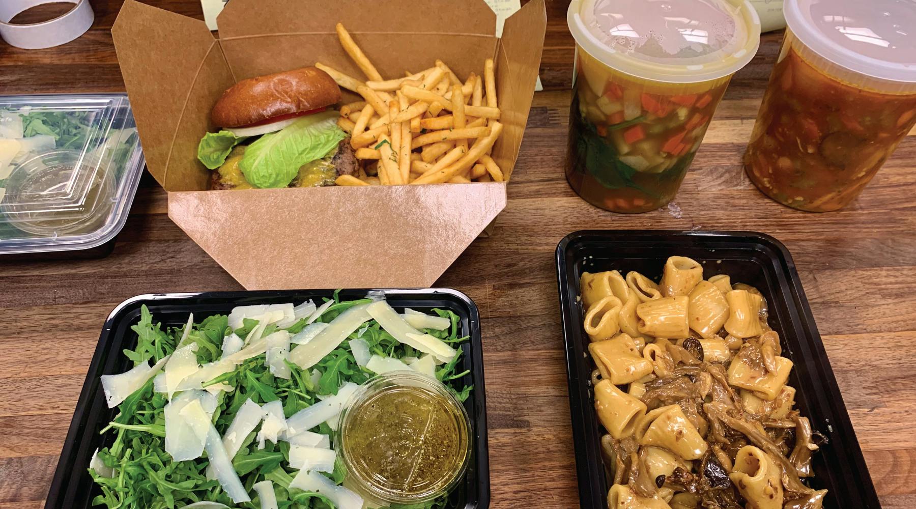 a box filled with different types of food on a wooden table