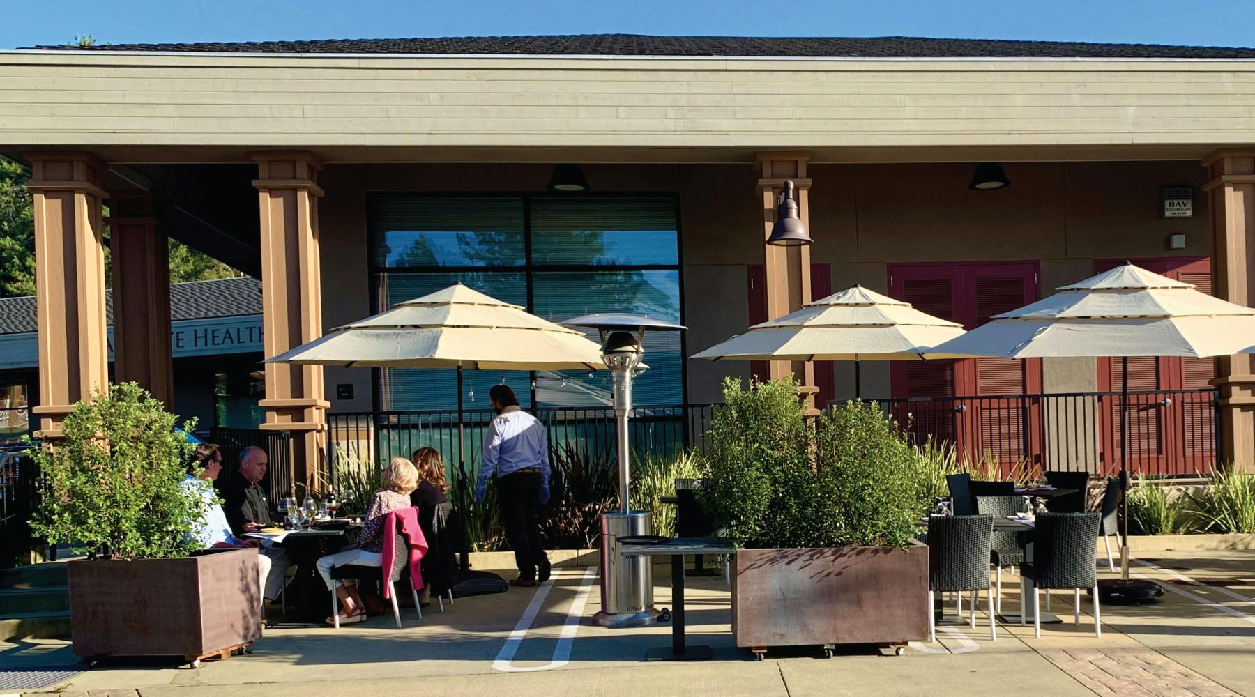 a person sitting on a bench in front of a building