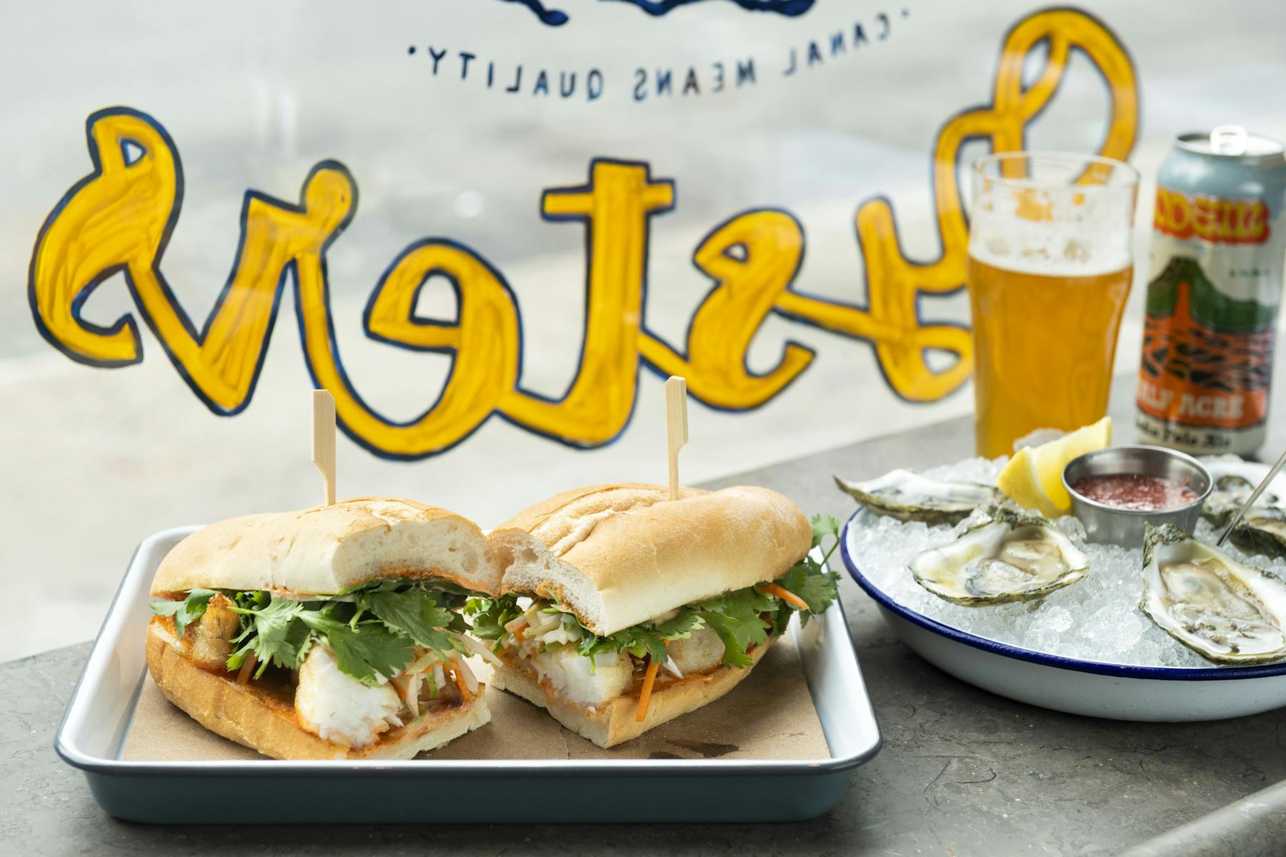 a can of food with a sandwich on a plate