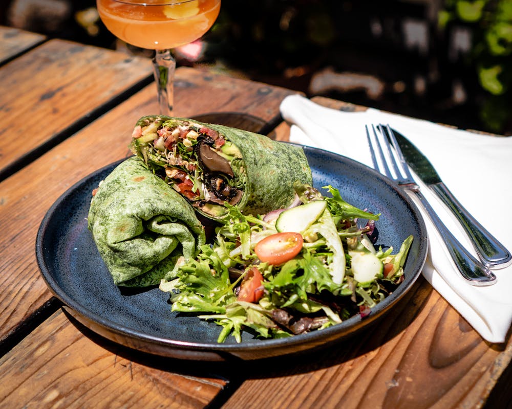 a plate of salad and a glass of wine