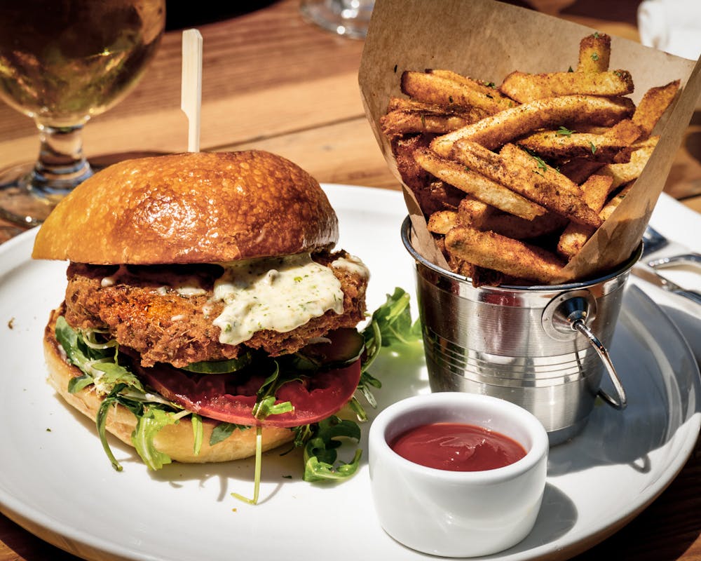 a close up of a sandwich and fries on a plate