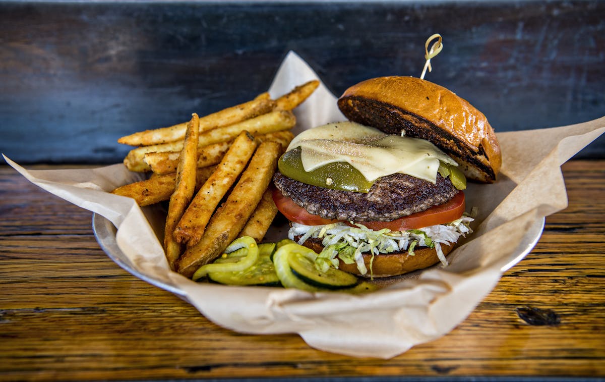 a plate with a sandwich and fries on a table