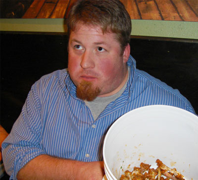 a man sitting at a table with a plate of food
