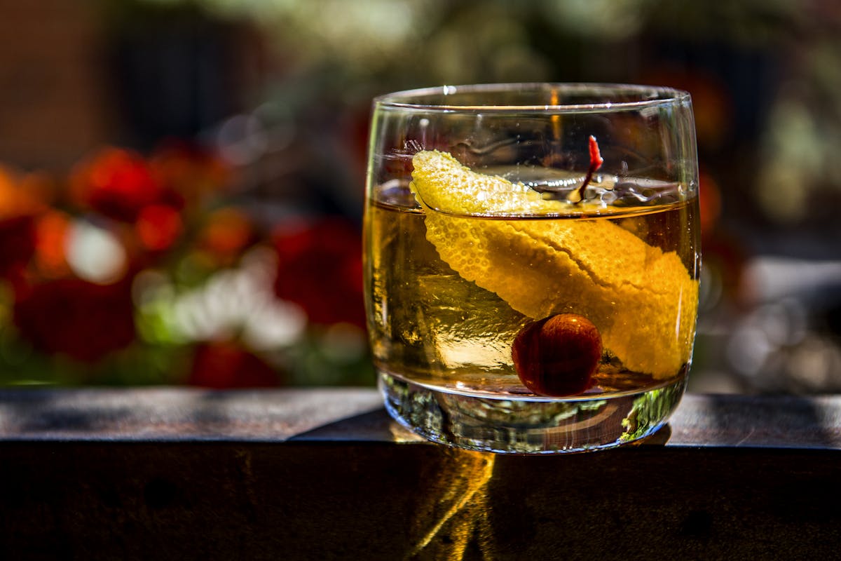 a close up of old fashioned glass in patio at West End Tavern