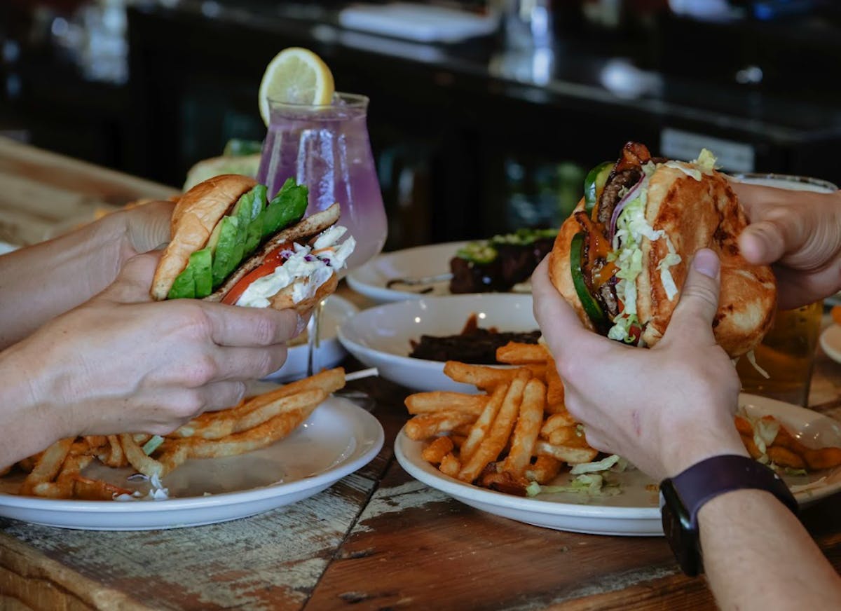 People holding burgers