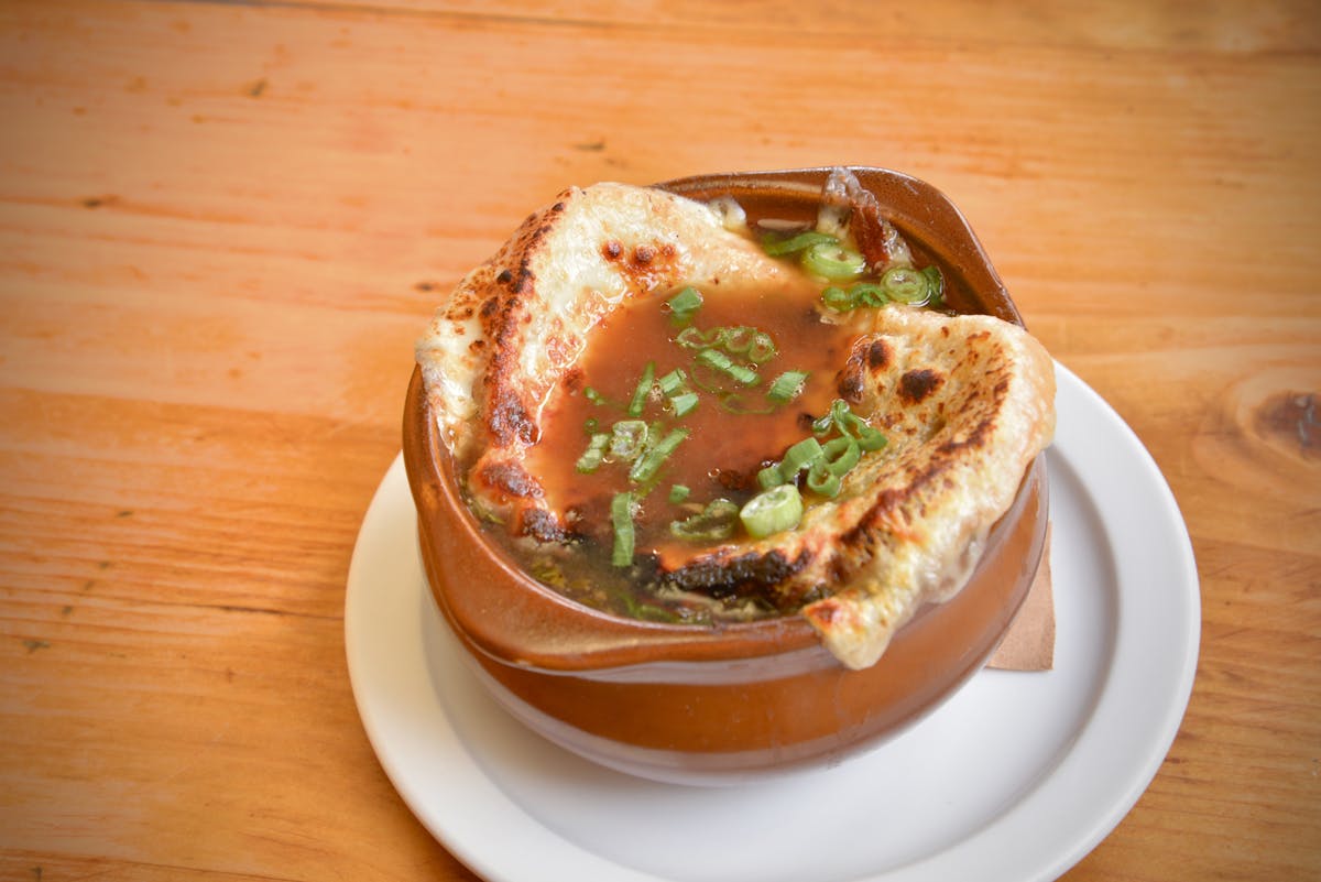 a plate of food sitting on top of a wooden table