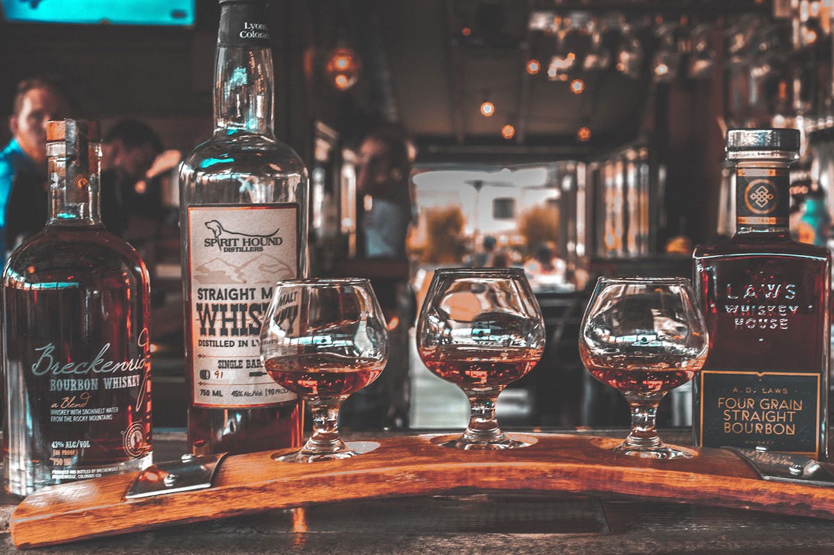 Glasses and bottles of whiskey on the bar
