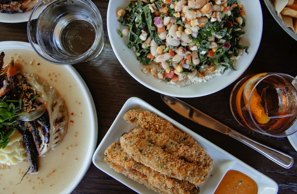 a plate of food and a glass of beer on a table