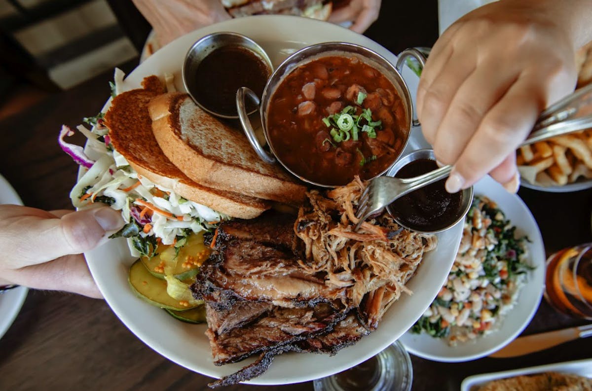 a plate of food and a glass of beer on a table