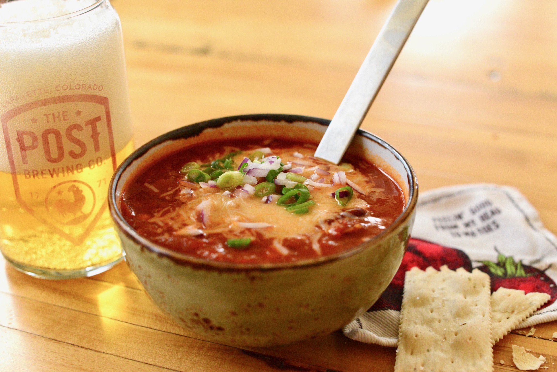 a plate of food and a glass of beer on a table