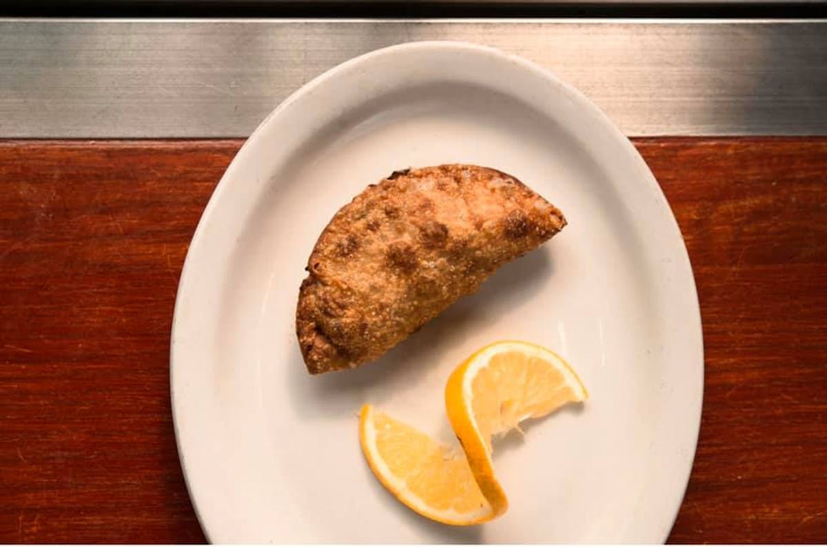 a piece of bread on a plate on a wooden table