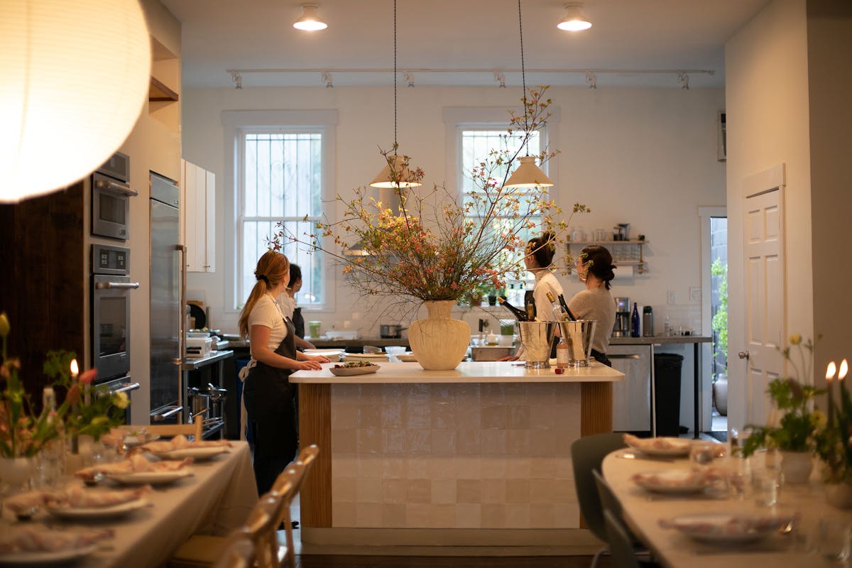 a kitchen with a sink and a dining table