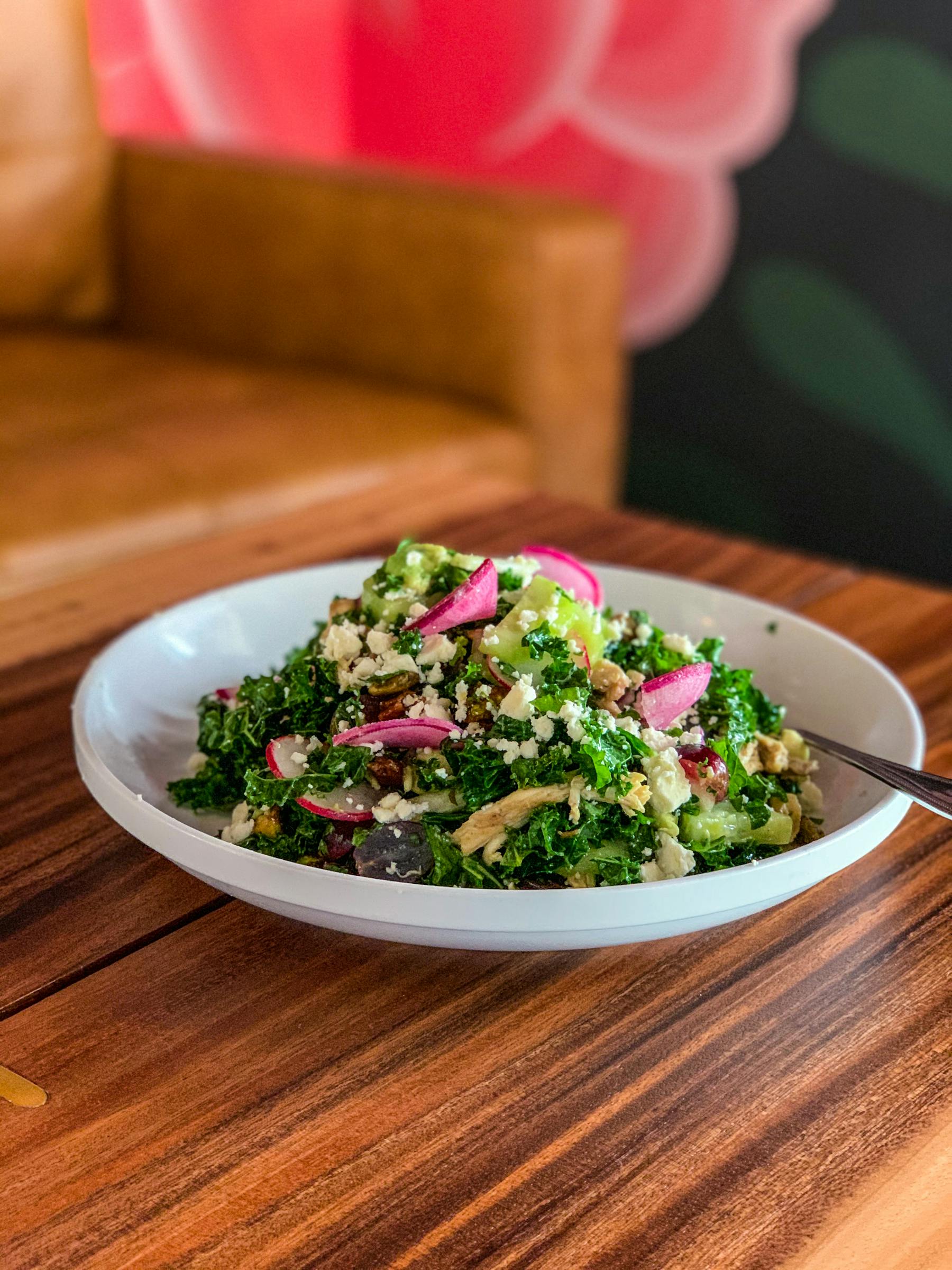 a bowl of food sitting on top of a wooden table