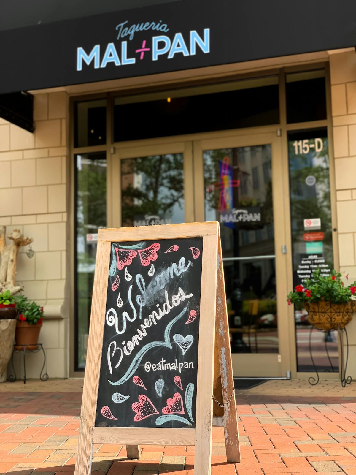 a sign above a store in a brick building