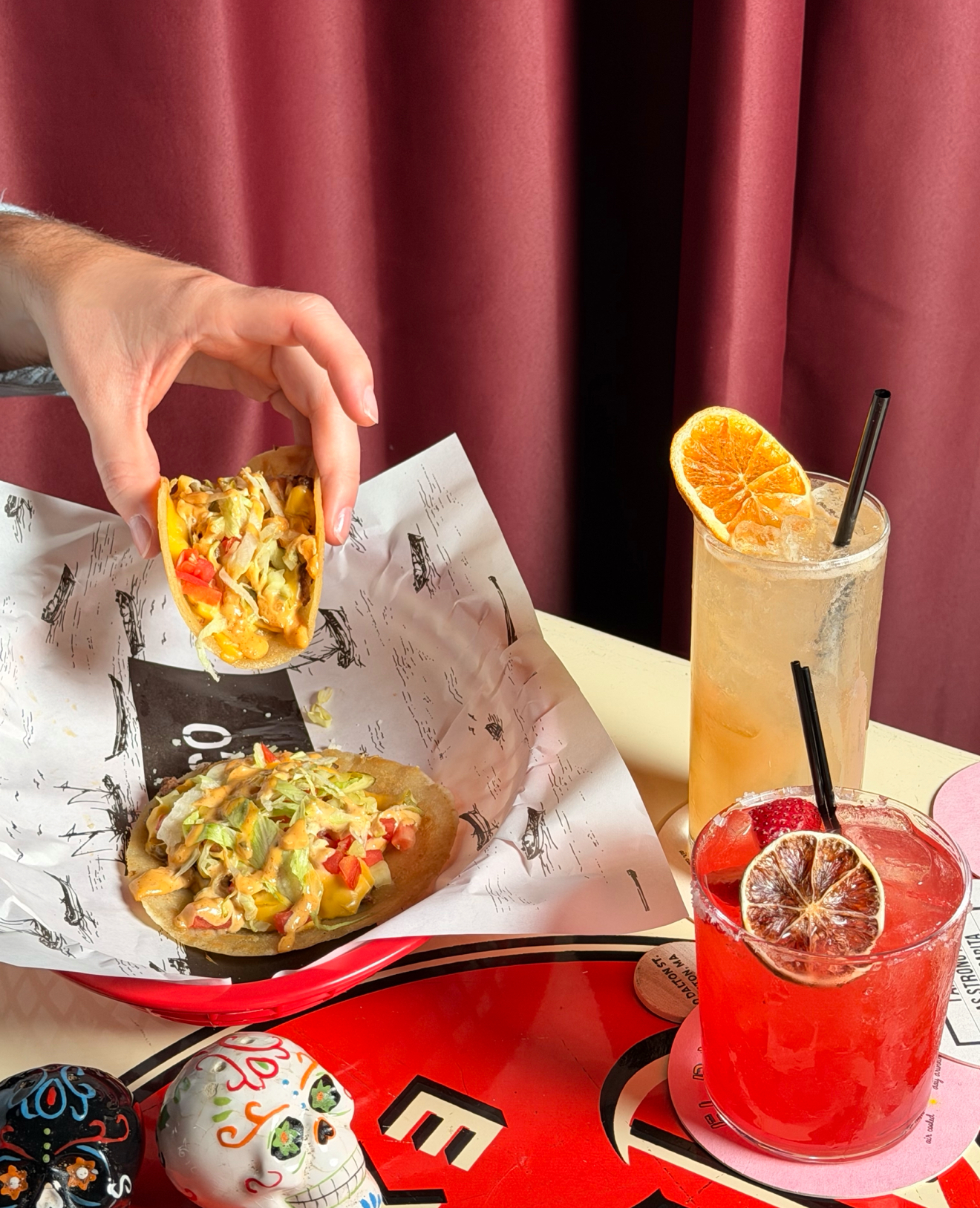 a woman holding a plate of food on a table
