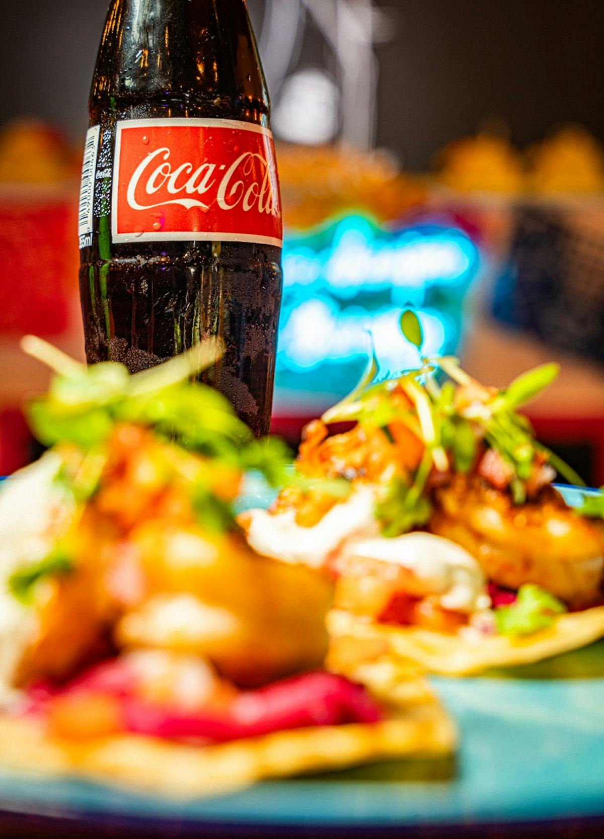a close up of a plate of food and a bottle of beer