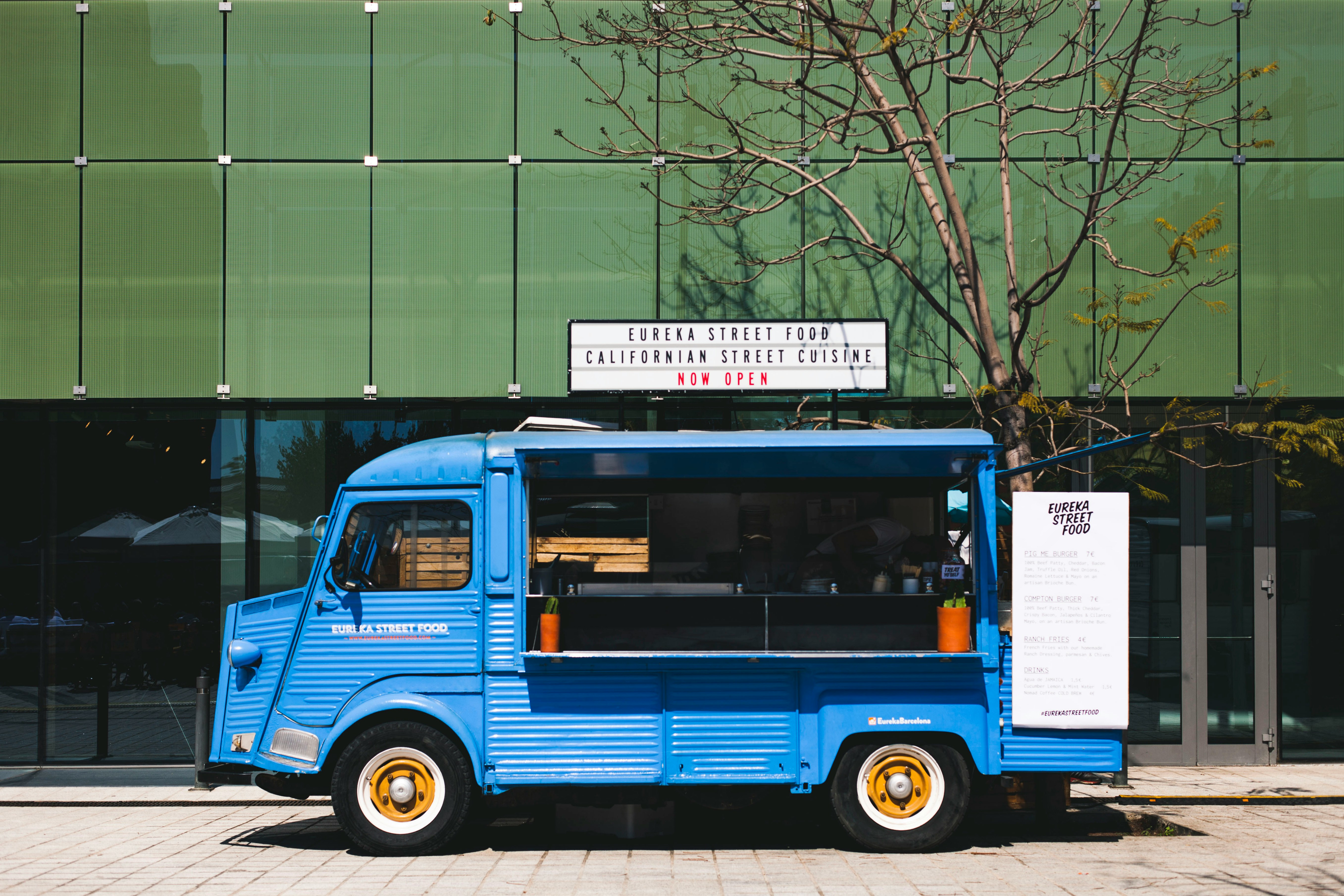 a blue truck parked in front of a building