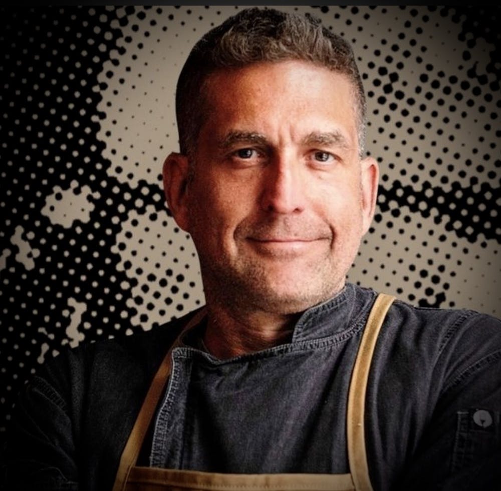 a man wearing glasses and looking at the camera