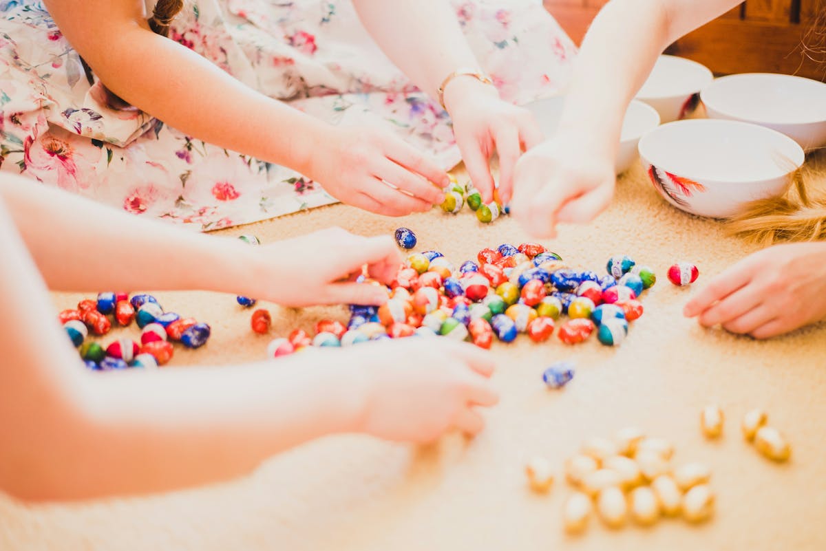 a little girl sitting at a table with a cake
