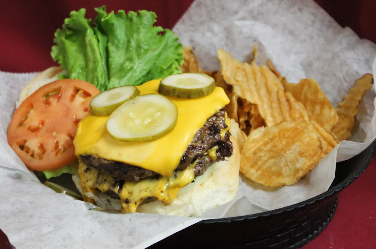a hamburger with chips