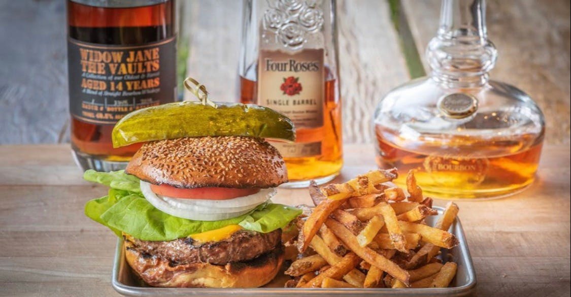 a close up of a sandwich and fries on a table