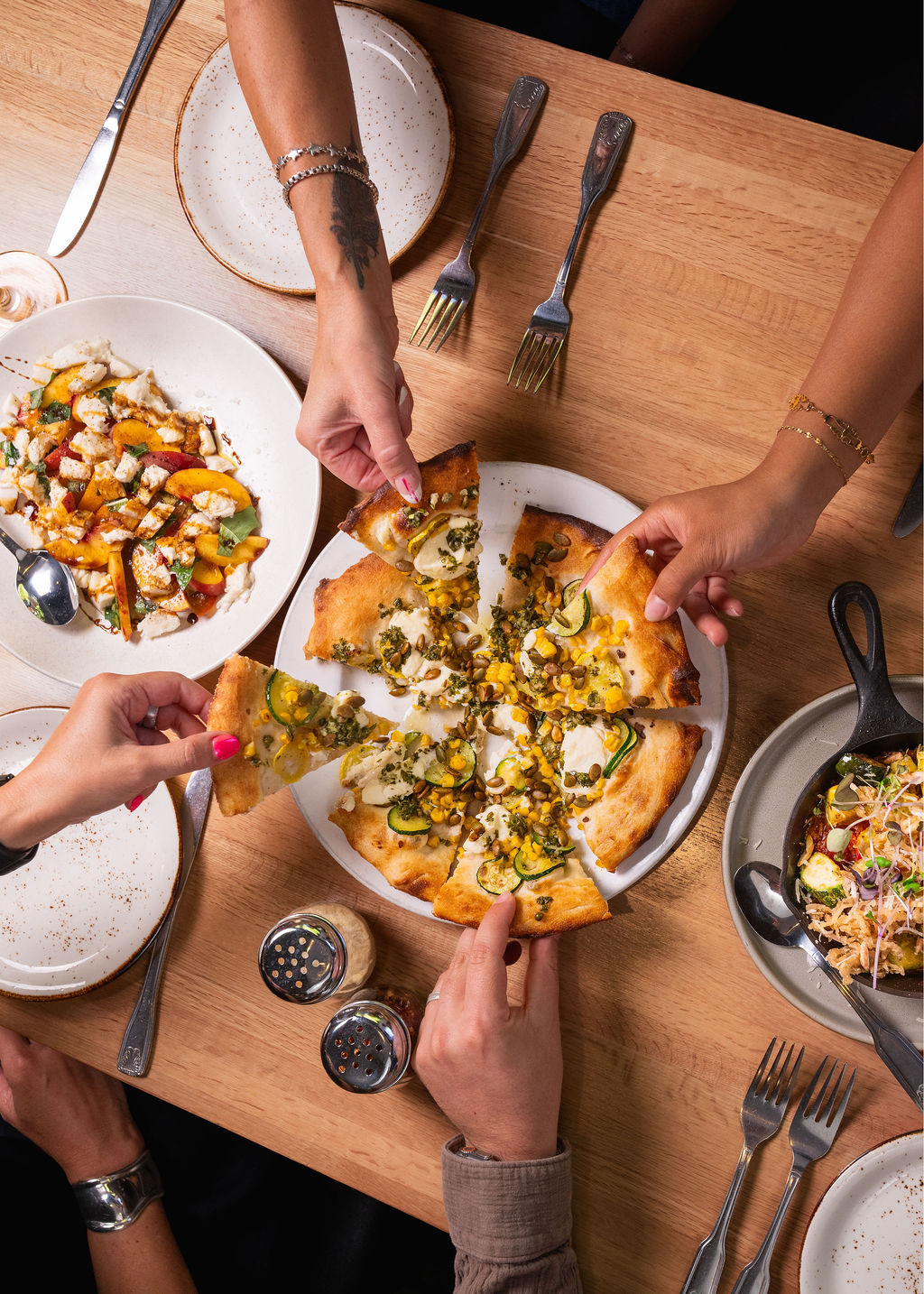 a group of people eating pizza