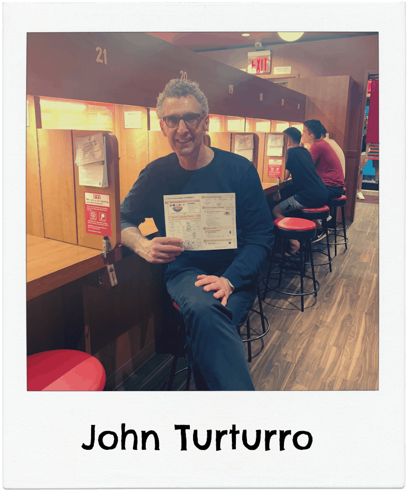 John Turturro sitting in Ichiran ramen