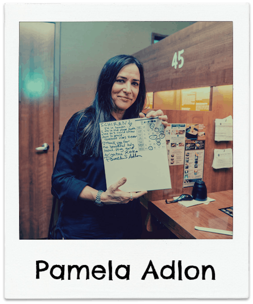 Pamela Adlon holding a sign