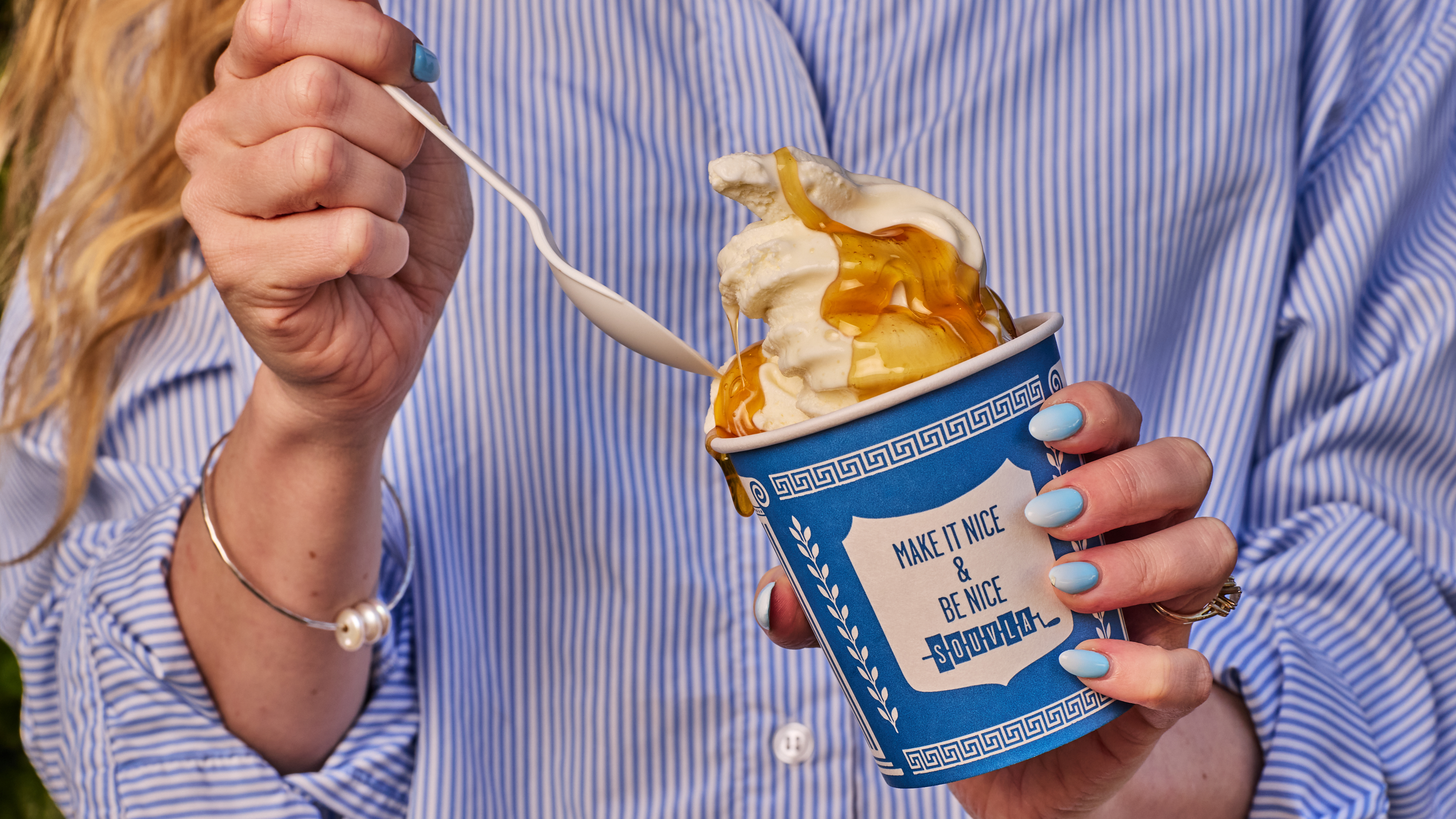 a person holding a cup of ice cream