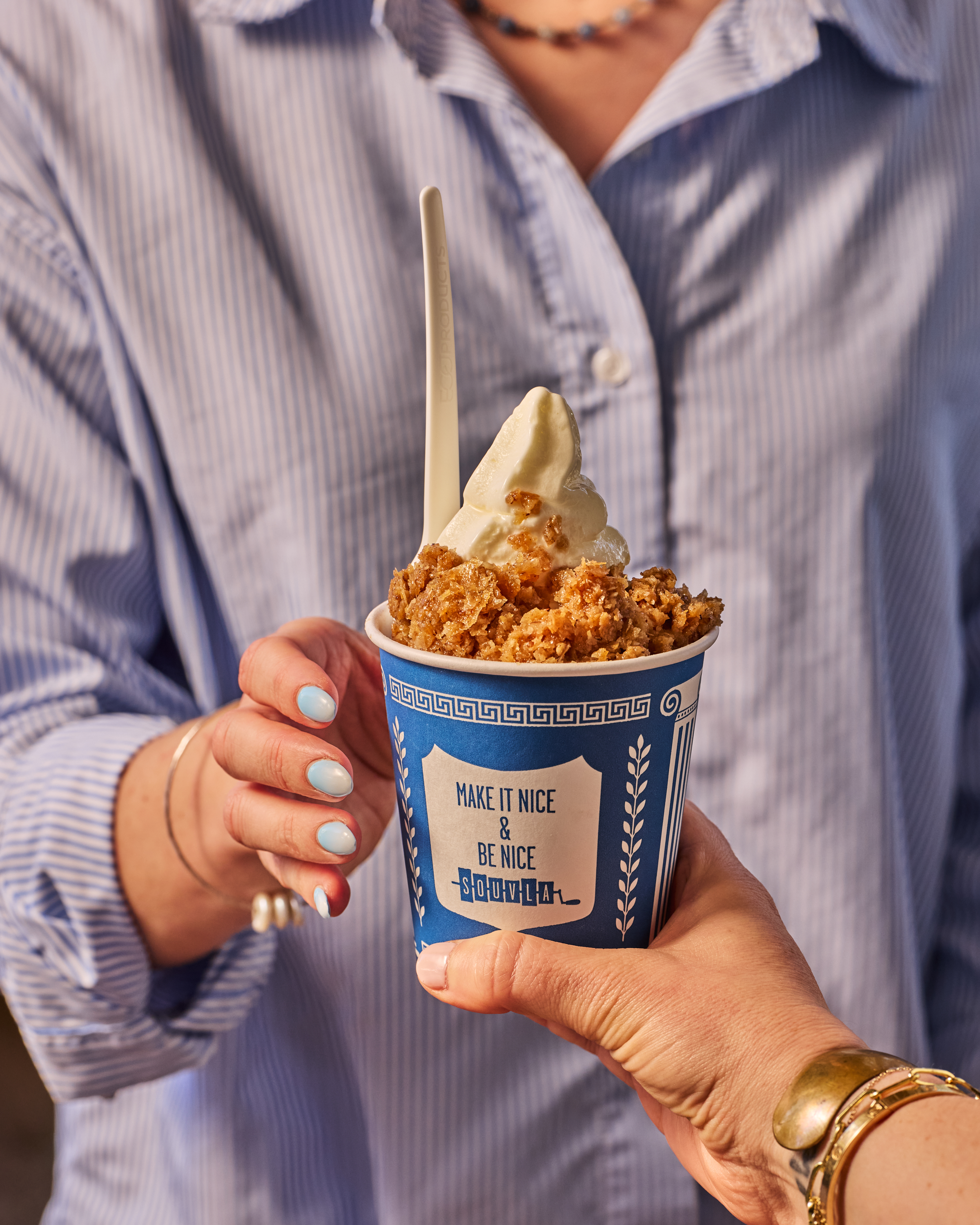 a person holding a cup of ice cream