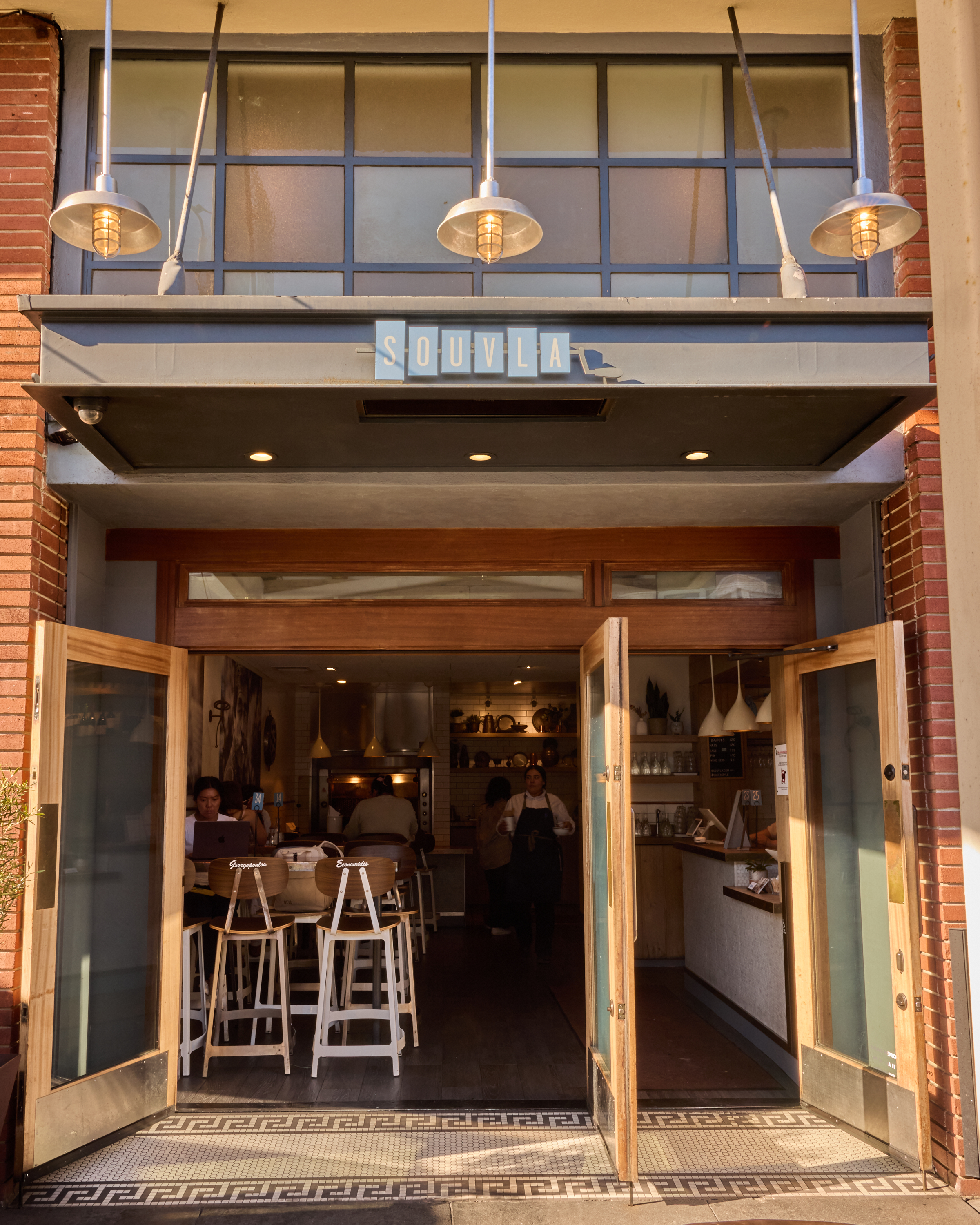 a building with a restaurant and people in the background