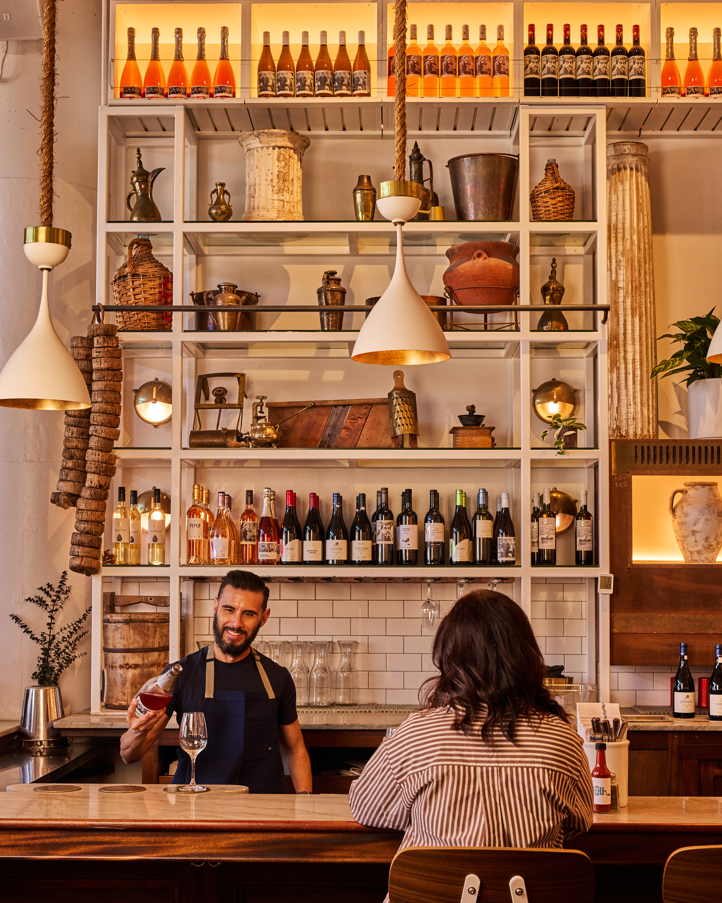 a man holding a glass of wine in front of a woman