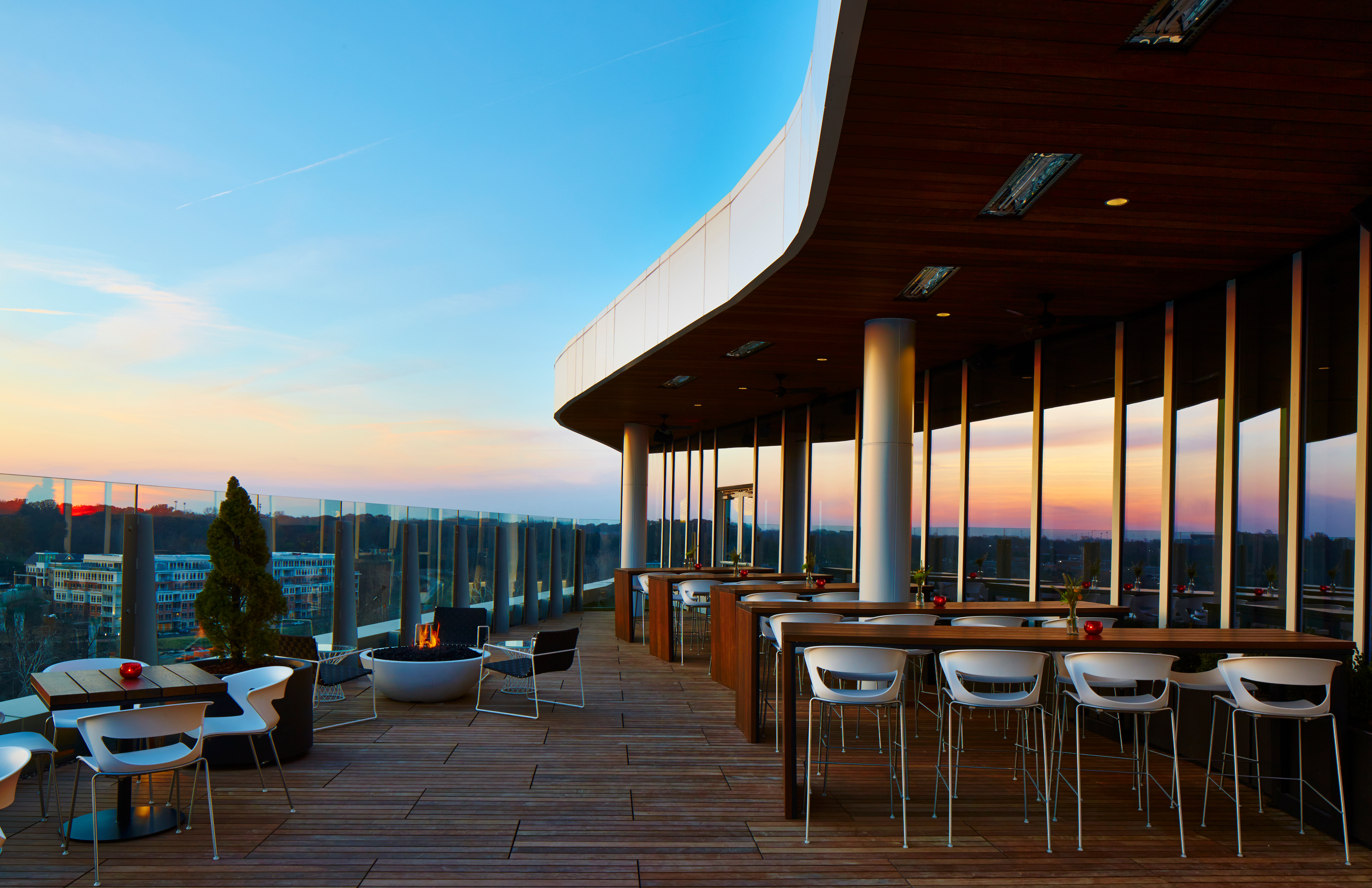 a patio with a fire pit and tables