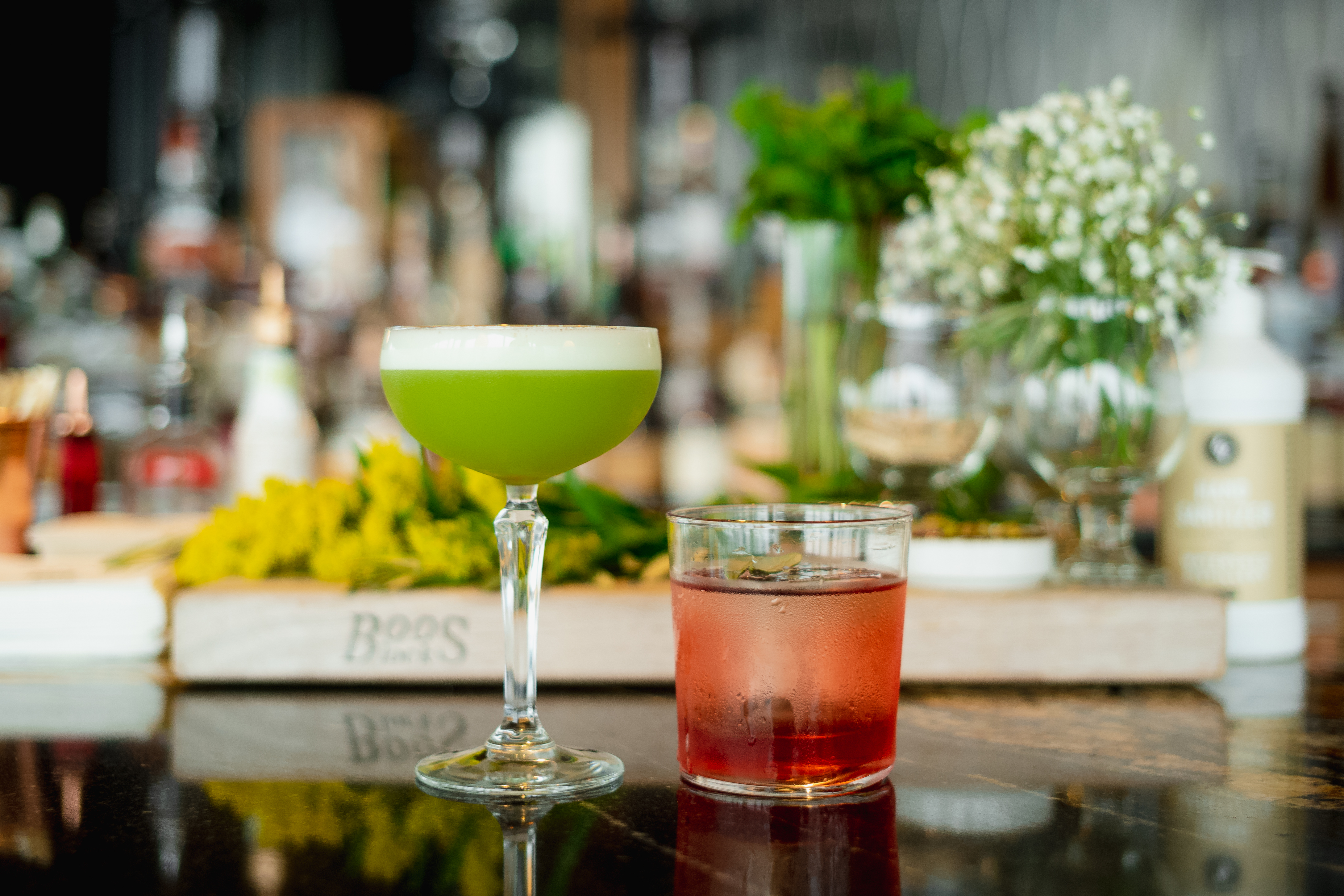 a two glasses of drinks on a table