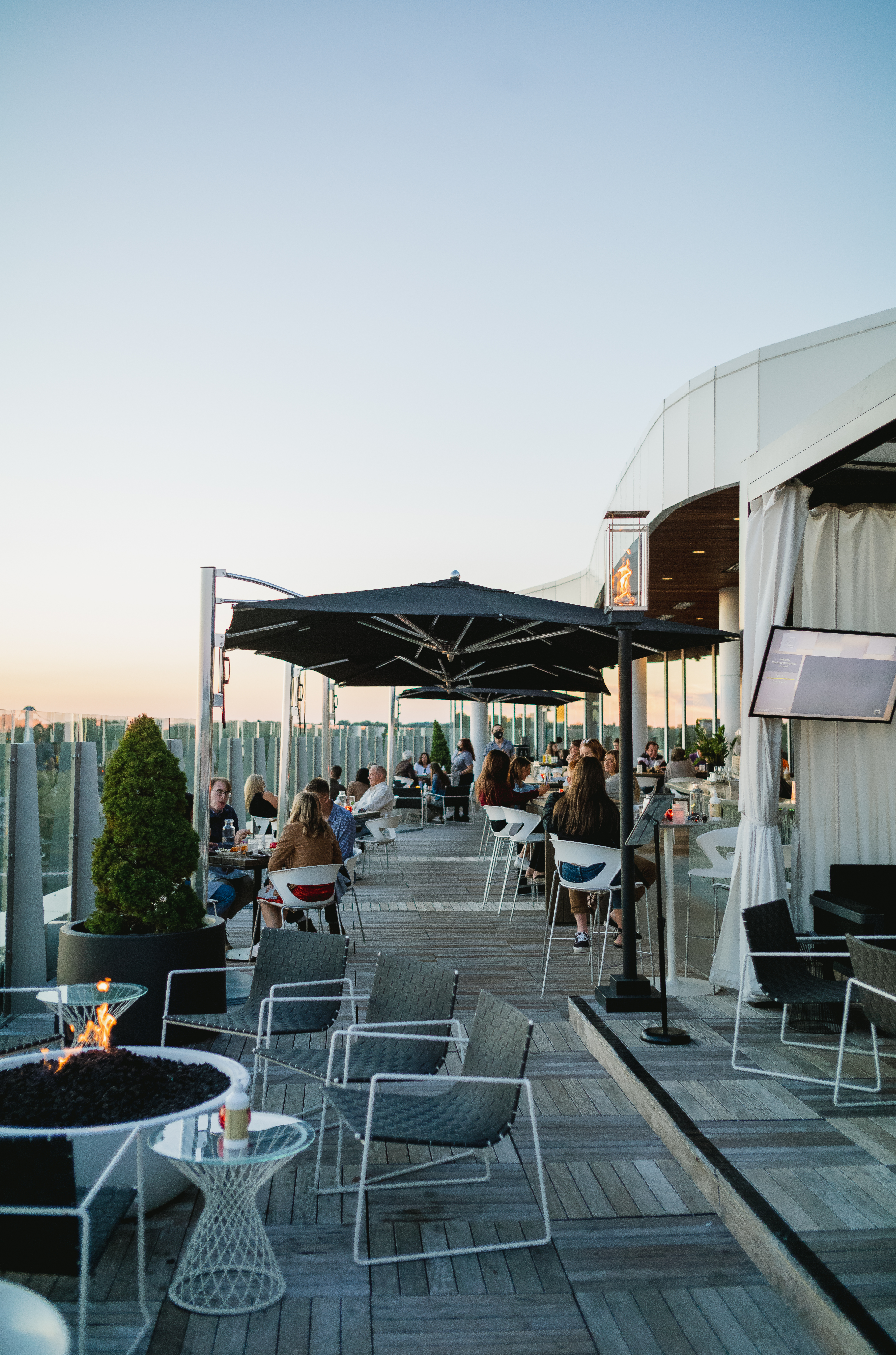 patio view with cabanas and fire pit and sunset view