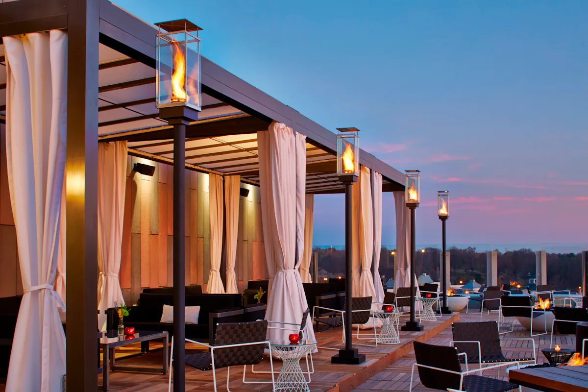 view of the rooftop with lamps, chairs and tables