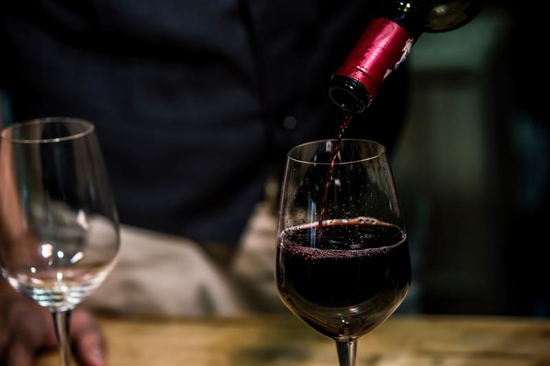 a close up of a bottle and a glass of wine