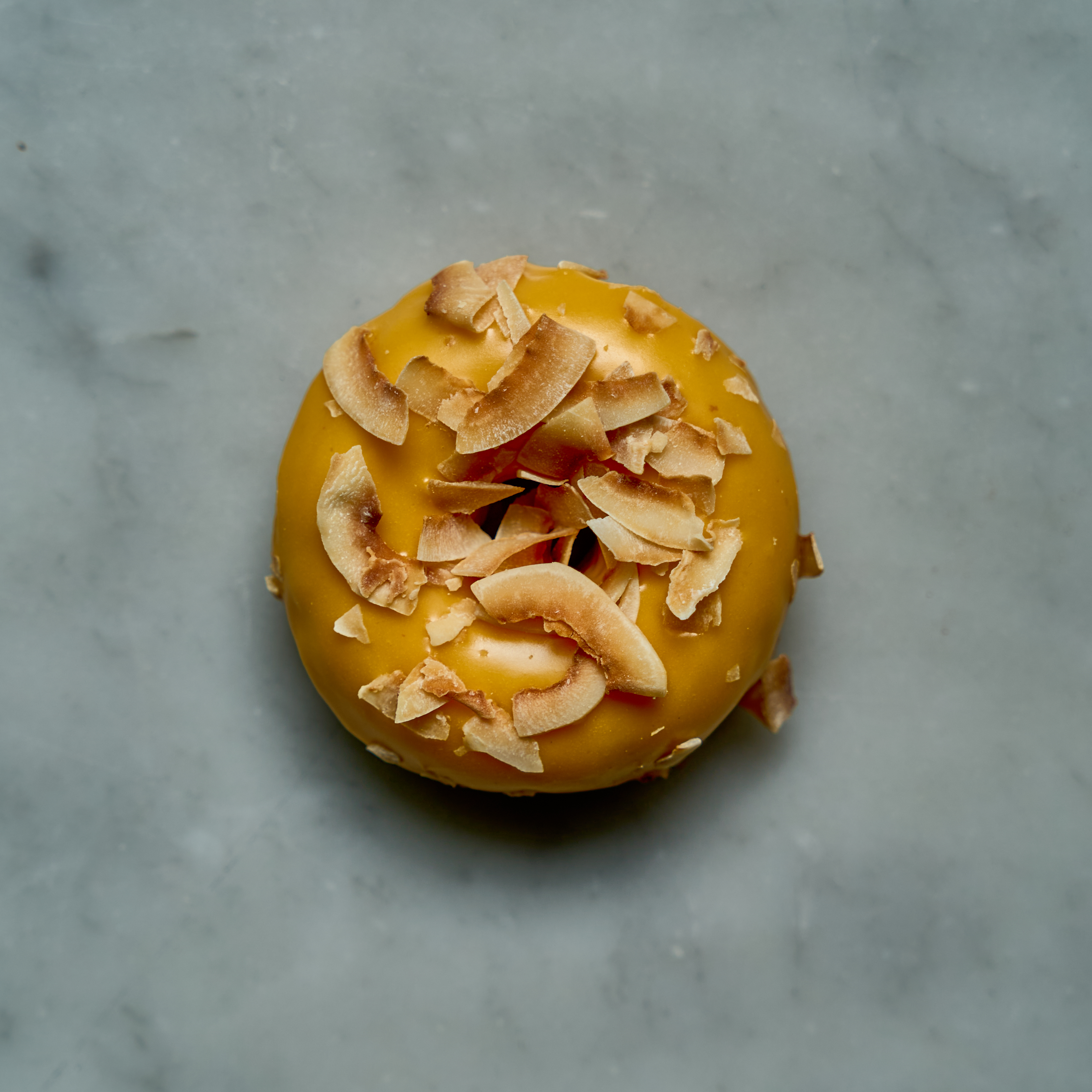 a donut with nuts on top