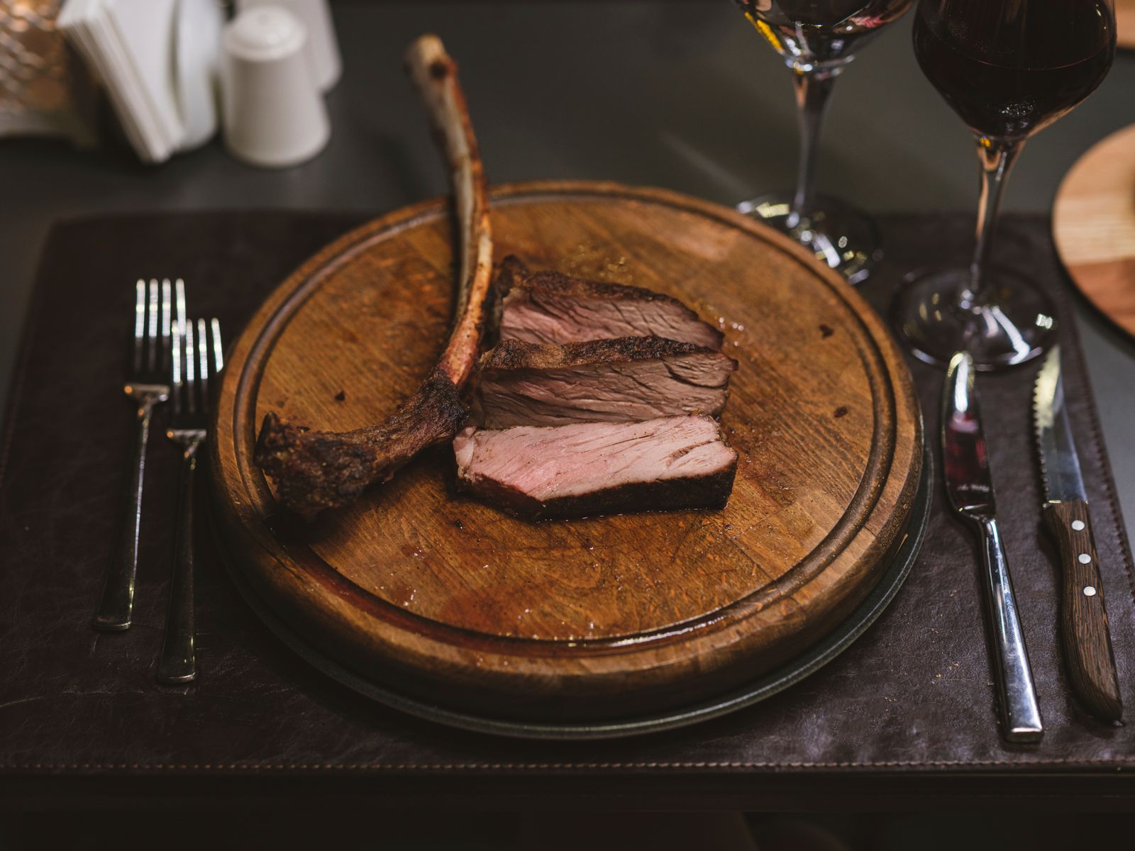 Sliced Picanha steak on a wooden board with red wine, served for Steak Night