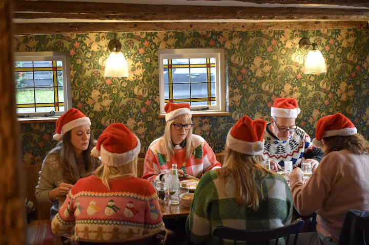 Christmas party guests in festive hats at The Fox & Hounds