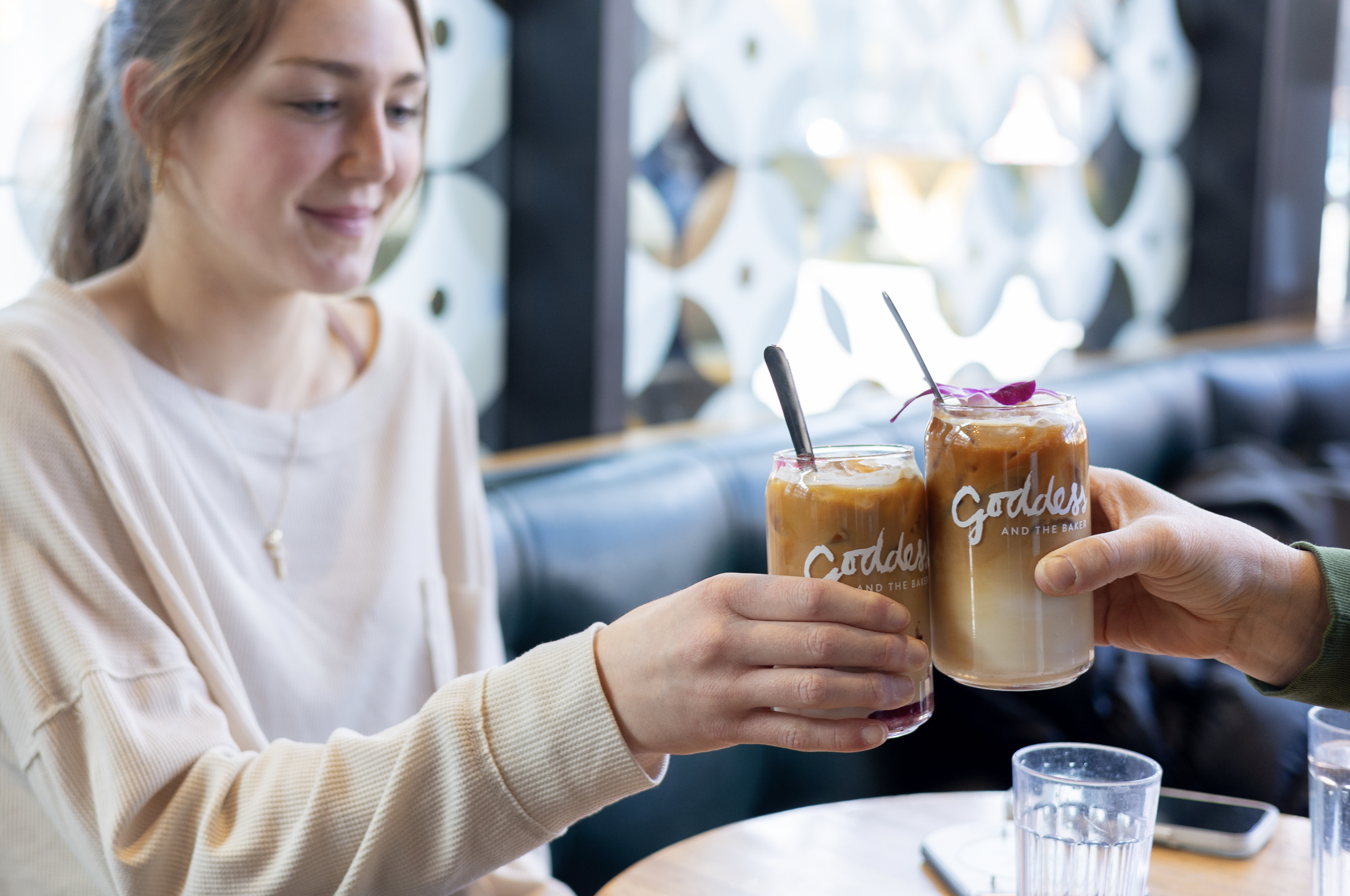 a woman holding a cup of coffee on a table