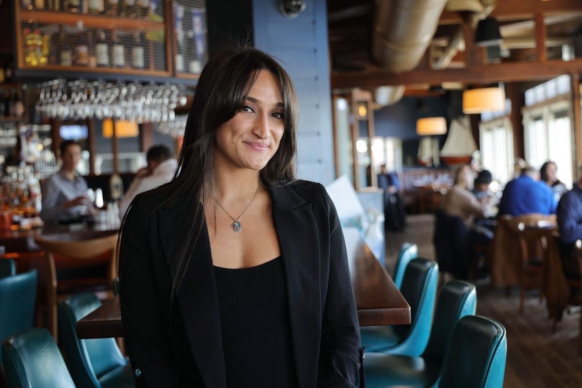 a woman sitting at a table in a restaurant