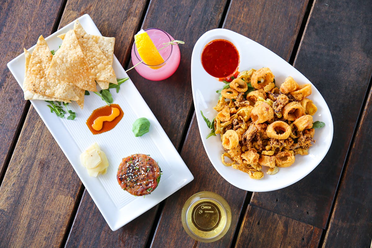 a plate of food sitting on top of a wooden table