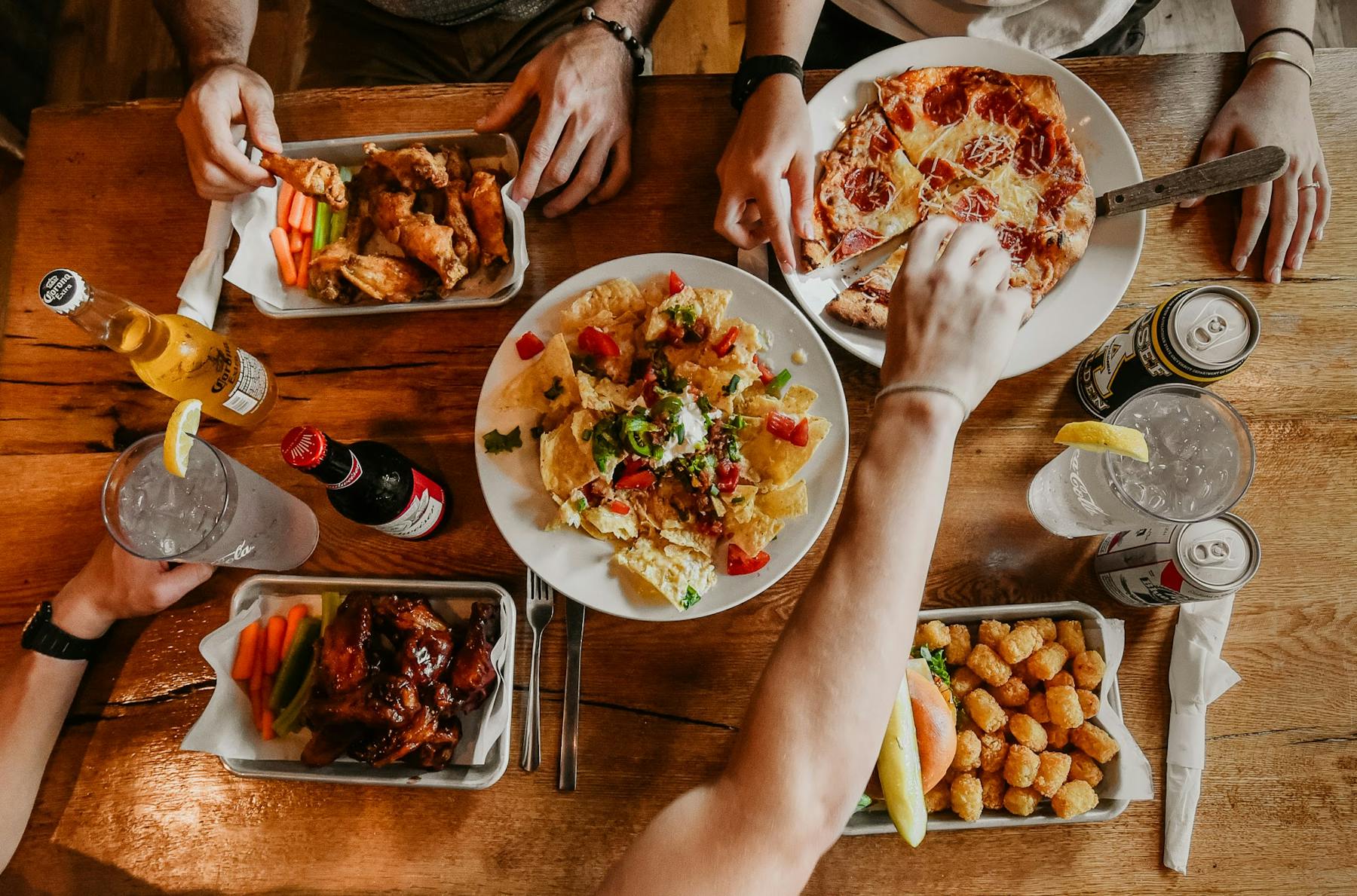 a group of people sitting at a table with a plate of food